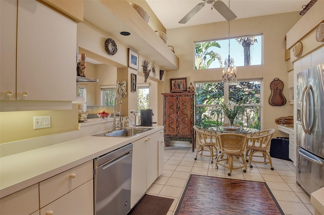 kitchen with plenty of natural light, stainless steel appliances, light countertops, and a sink