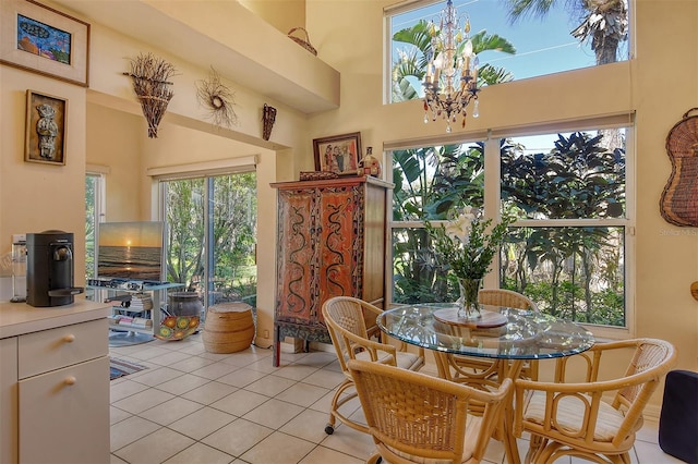 dining room featuring an inviting chandelier, a high ceiling, and light tile patterned floors