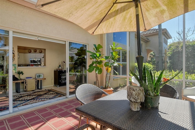 sunroom with a ceiling fan and vaulted ceiling