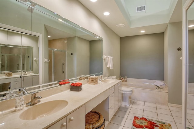 bathroom with a sink, visible vents, double vanity, and tile patterned flooring