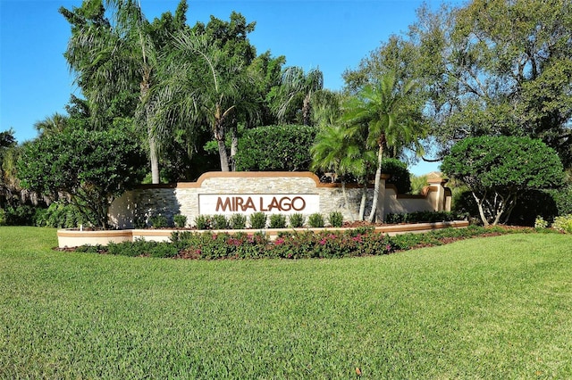 community sign featuring a lawn