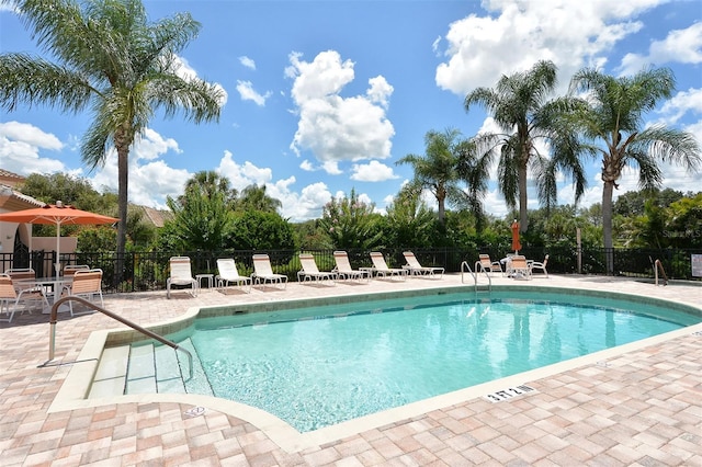 pool featuring a patio area and fence