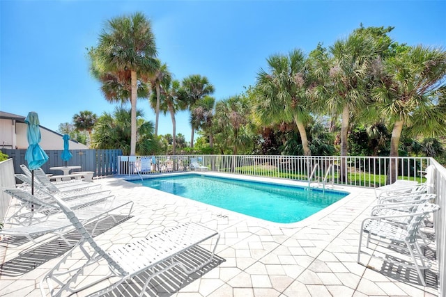 pool featuring a patio area and fence