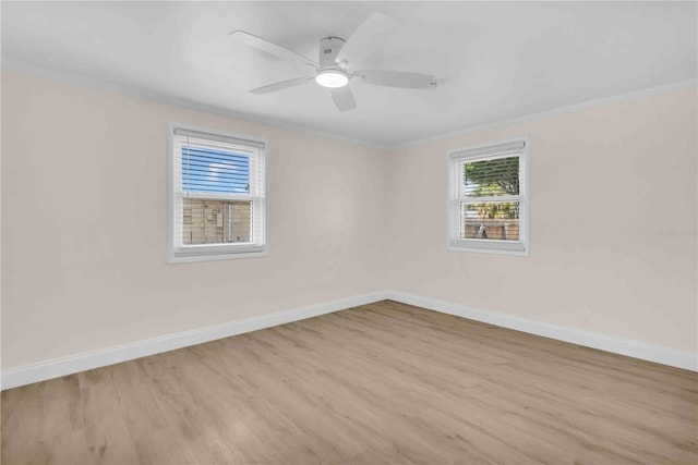 unfurnished room featuring ceiling fan, ornamental molding, light wood-style floors, and baseboards