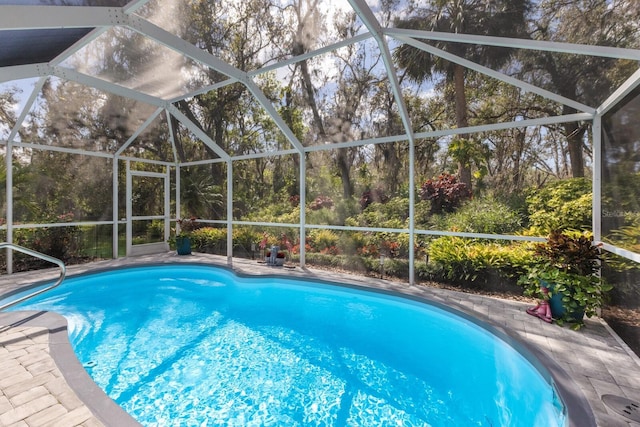 pool featuring a patio area and glass enclosure