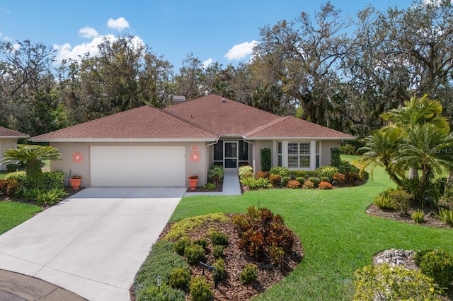 view of front of home featuring a garage, driveway, roof with shingles, stucco siding, and a front yard