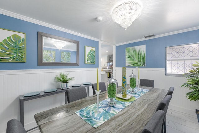 dining space with marble finish floor, wainscoting, visible vents, and an inviting chandelier