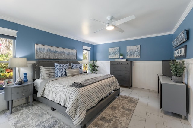 bedroom with marble finish floor, wainscoting, a ceiling fan, and crown molding