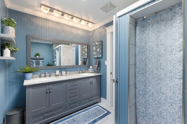 full bathroom featuring double vanity, a shower, ornamental molding, and a sink