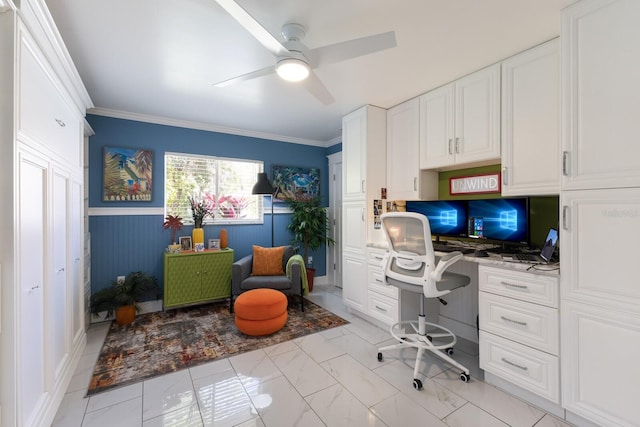 office with a wainscoted wall, ceiling fan, crown molding, and built in study area