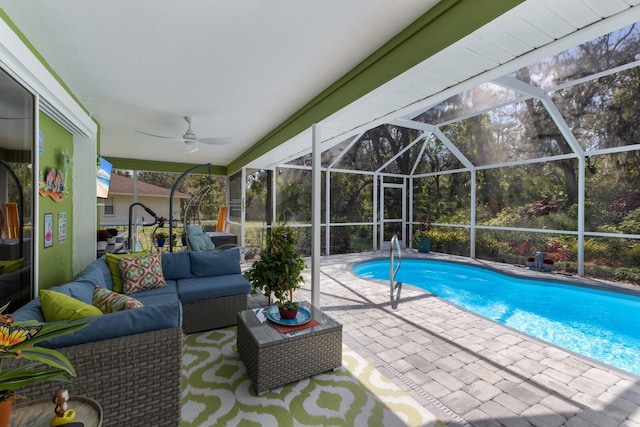 outdoor pool with a ceiling fan, a lanai, a patio, and an outdoor hangout area