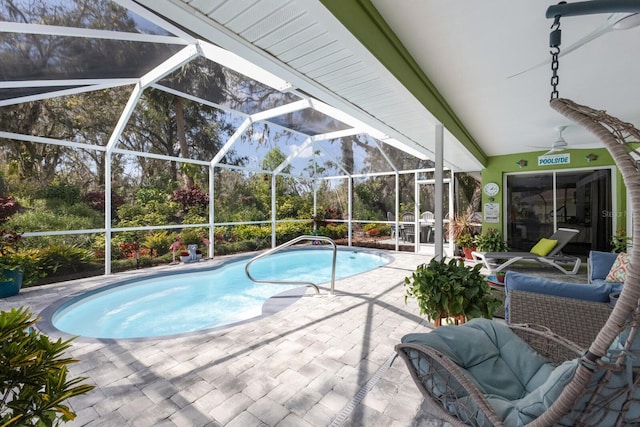 outdoor pool with a lanai and a patio area