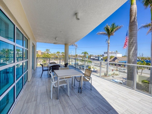 6512 Midnight Pass Rd Unit 504, Sarasota, FL 34242 - wooden terrace with outdoor dining space