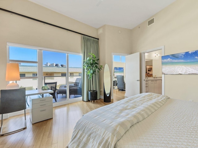 6512 Midnight Pass Rd Unit 504, Sarasota, FL 34242 - bedroom with a high ceiling, light wood finished floors, and connected bathroom