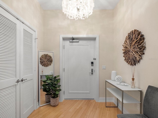 6512 Midnight Pass Rd Unit 504, Sarasota, FL 34242 - entrance foyer featuring light wood-style floors and a chandelier