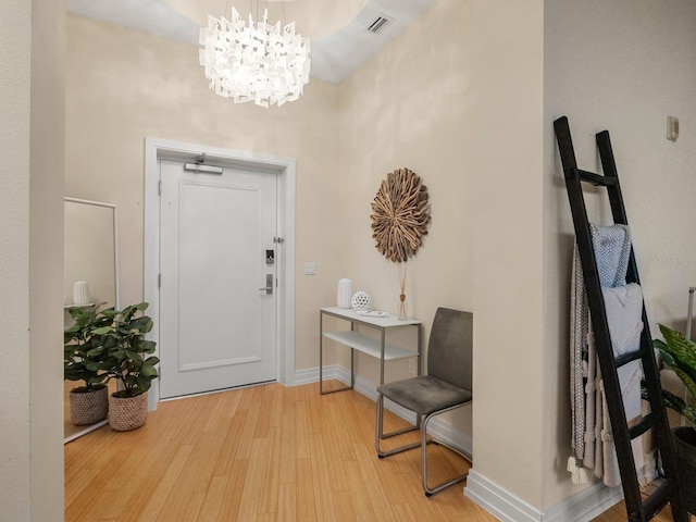6512 Midnight Pass Rd Unit 504, Sarasota, FL 34242 - entrance foyer featuring light wood-style floors and a chandelier