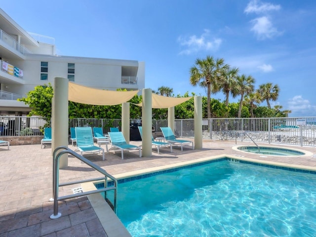6512 Midnight Pass Rd Unit 504, Sarasota, FL 34242 - community pool featuring a patio and a community hot tub