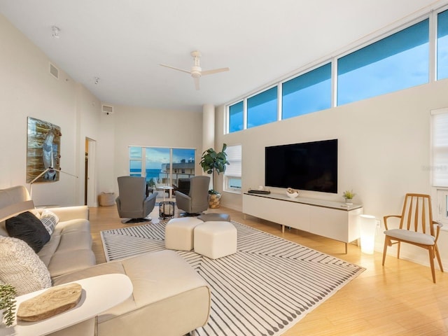6512 Midnight Pass Rd Unit 504, Sarasota, FL 34242 - living area featuring a ceiling fan, light wood finished floors, and a high ceiling
