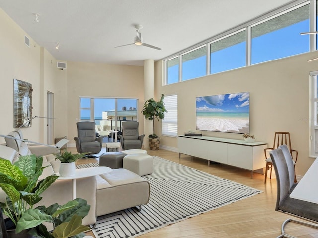 6512 Midnight Pass Rd Unit 504, Sarasota, FL 34242 - living area featuring a towering ceiling, a ceiling fan, and wood finished floors