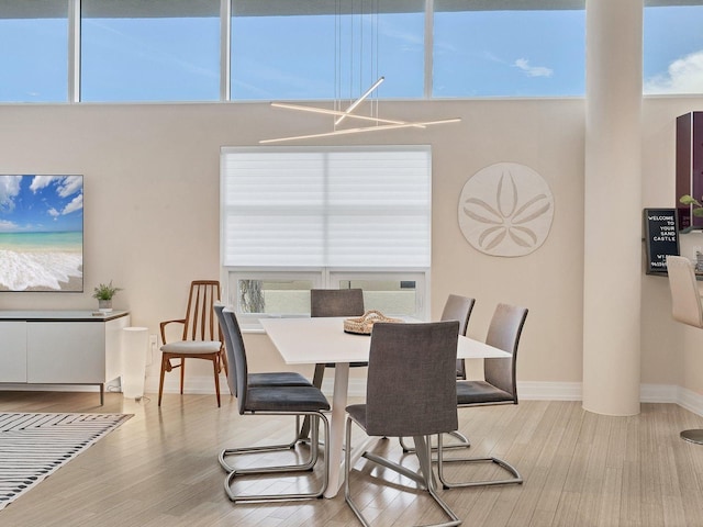 6512 Midnight Pass Rd Unit 504, Sarasota, FL 34242 - dining space with wood finished floors and a towering ceiling