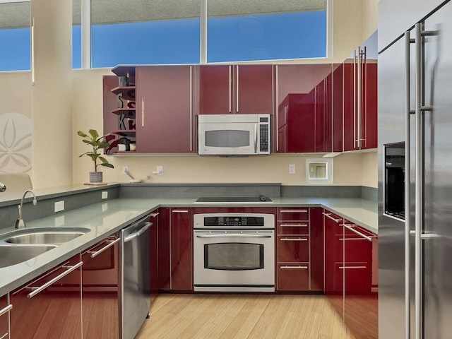 6512 Midnight Pass Rd Unit 504, Sarasota, FL 34242 - kitchen featuring appliances with stainless steel finishes, red cabinetry, light wood-style flooring, and open shelves