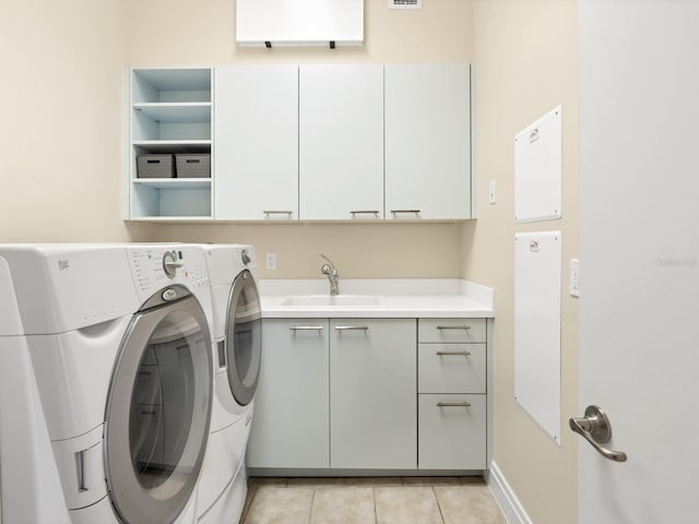 6512 Midnight Pass Rd Unit 504, Sarasota, FL 34242 - laundry area with cabinet space, washing machine and dryer, and light tile patterned floors