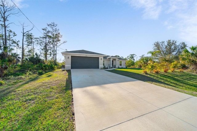 view of front of home with stucco siding, an attached garage, driveway, and a front lawn