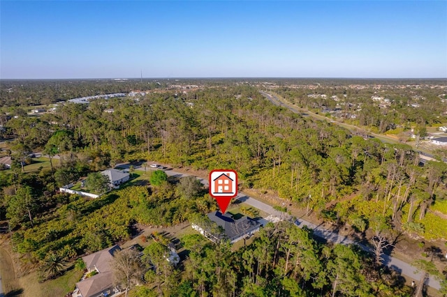 birds eye view of property with a forest view