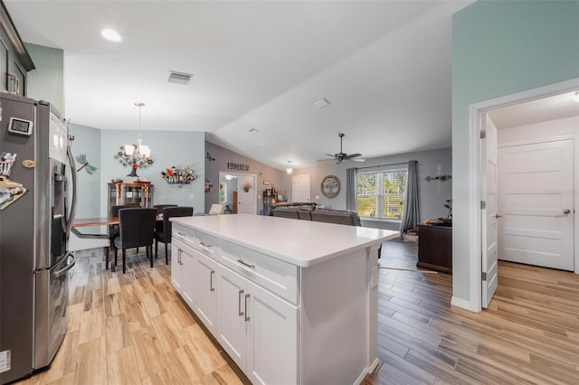 kitchen featuring visible vents, stainless steel refrigerator with ice dispenser, open floor plan, light wood-style floors, and lofted ceiling