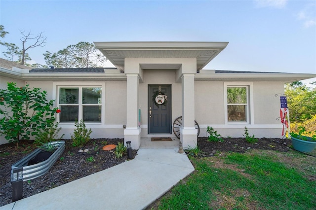 property entrance with stucco siding