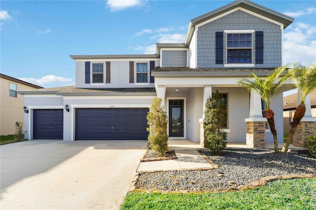 view of front of property with concrete driveway, a porch, an attached garage, and stucco siding