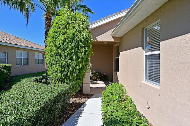 view of side of home with stucco siding