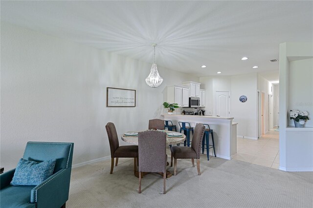 dining space featuring recessed lighting, visible vents, baseboards, light colored carpet, and light tile patterned flooring