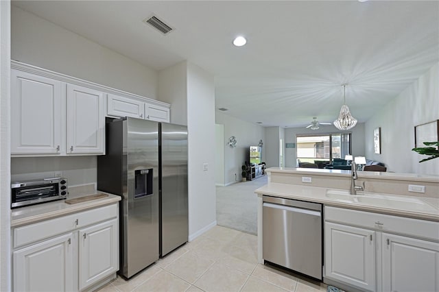 kitchen featuring a toaster, a sink, visible vents, open floor plan, and appliances with stainless steel finishes