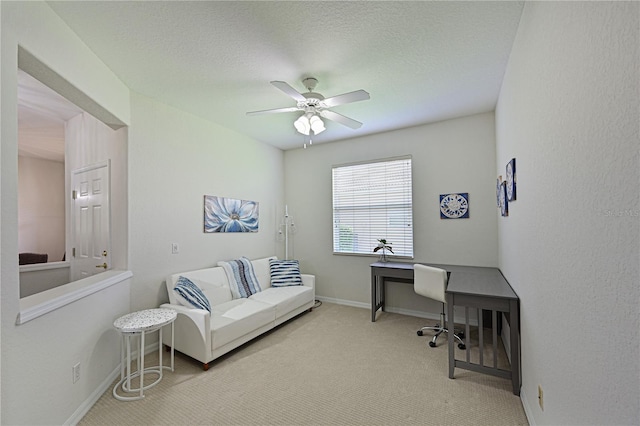 office area featuring ceiling fan, carpet floors, a textured ceiling, and baseboards