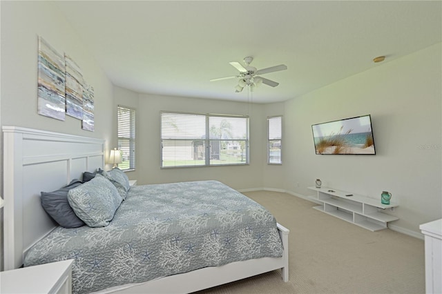 carpeted bedroom featuring ceiling fan and baseboards