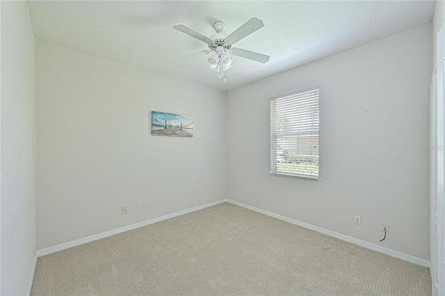 empty room with ceiling fan, carpet flooring, and baseboards