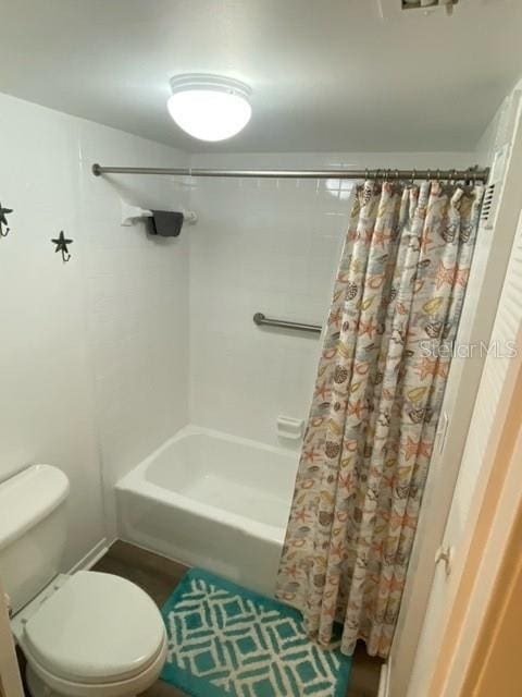 bathroom with shower / bathtub combination with curtain and toilet