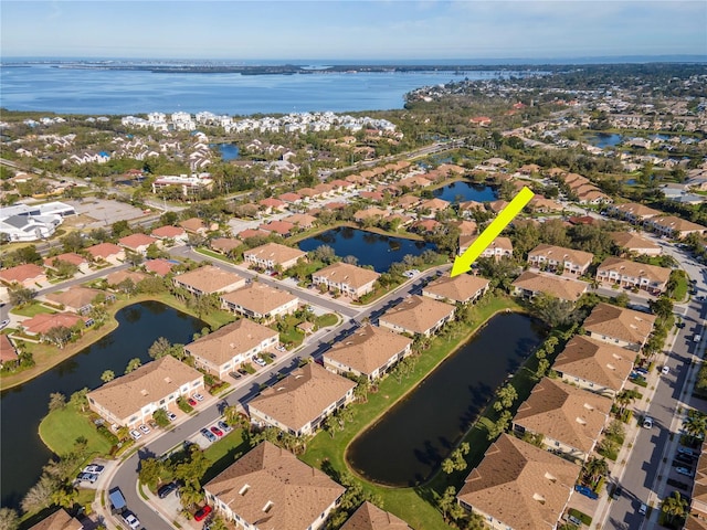 birds eye view of property featuring a residential view and a water view