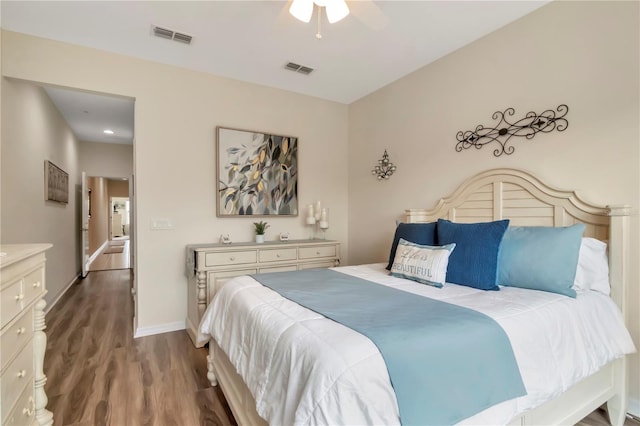 bedroom featuring a ceiling fan, baseboards, visible vents, and dark wood-style flooring