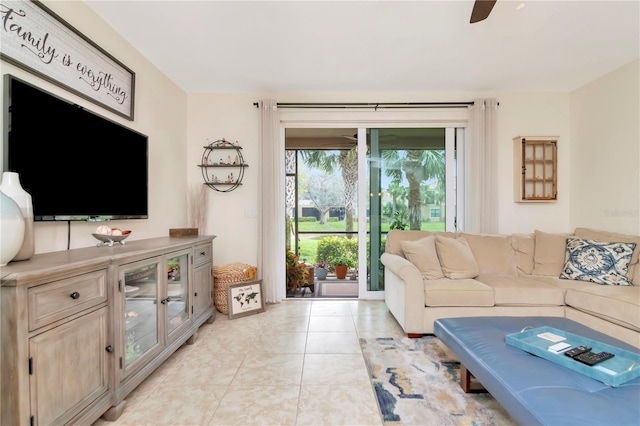 living area featuring light tile patterned floors and a ceiling fan