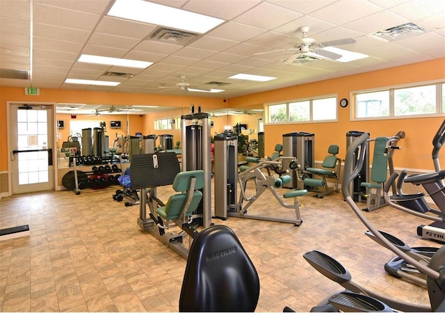 gym featuring visible vents, a paneled ceiling, and a ceiling fan