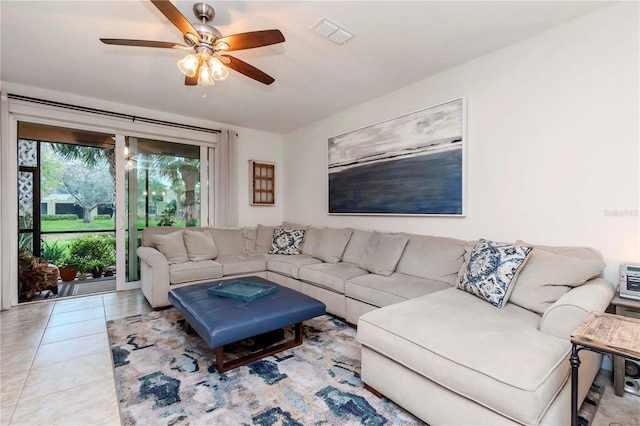 tiled living room featuring visible vents and a ceiling fan