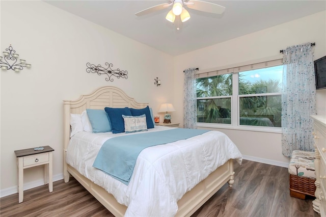 bedroom featuring a ceiling fan, baseboards, and wood finished floors