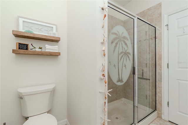 bathroom featuring toilet and a shower stall