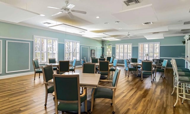 dining area with ceiling fan, visible vents, and wood finished floors