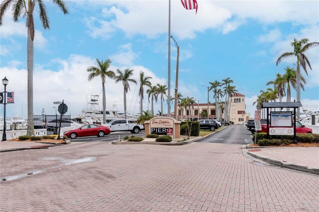 view of road with curbs, traffic signs, street lighting, and sidewalks