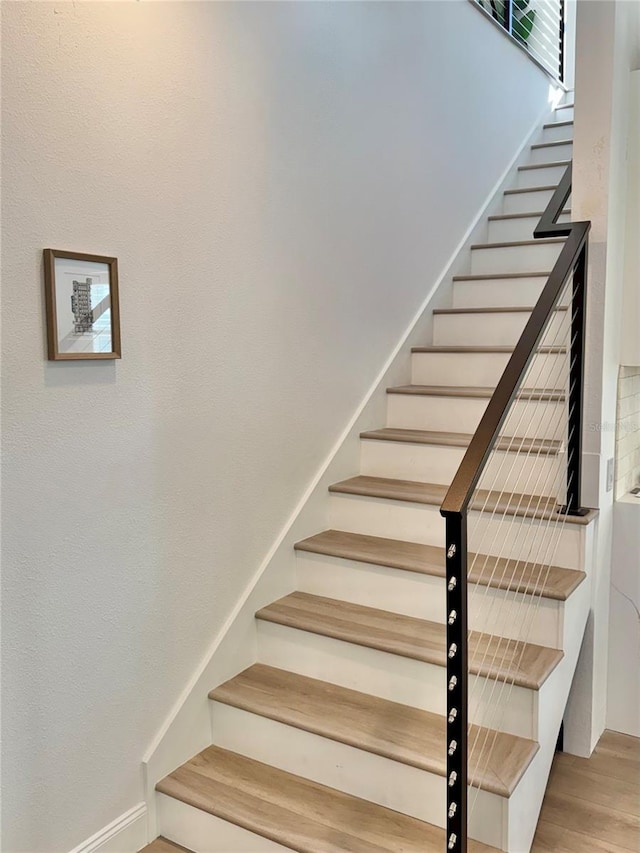 stairway with wood finished floors