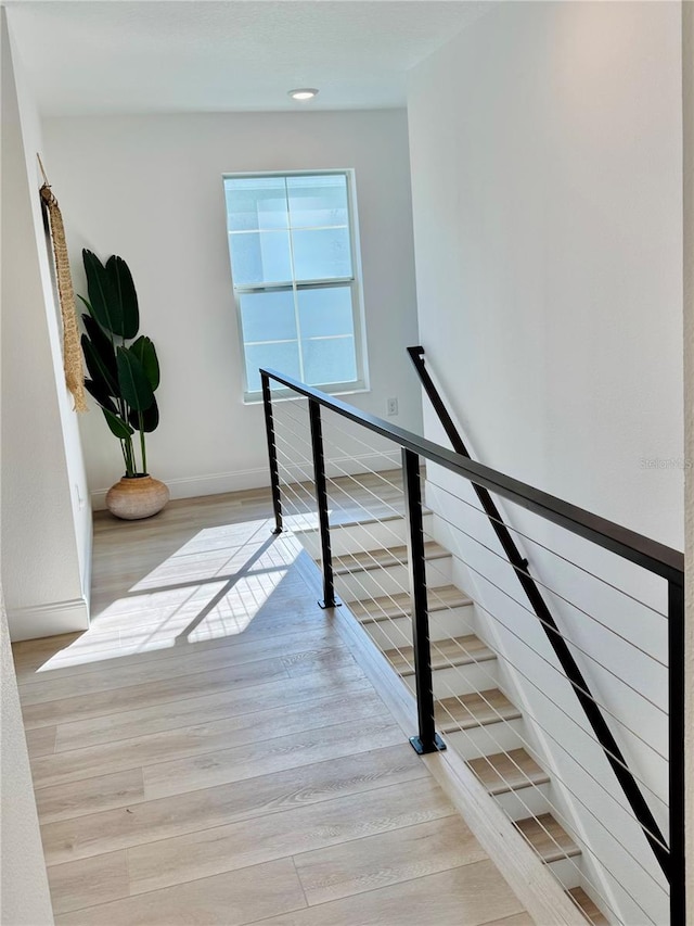 stairs featuring baseboards and wood finished floors