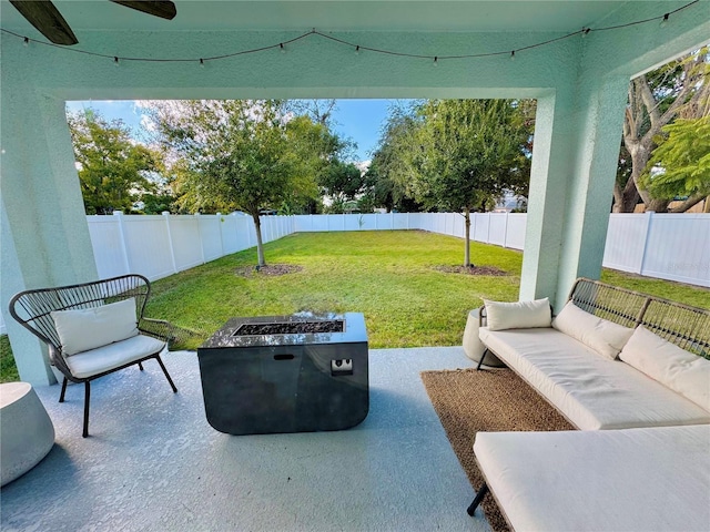 view of patio / terrace featuring an outdoor living space with a fire pit and a fenced backyard